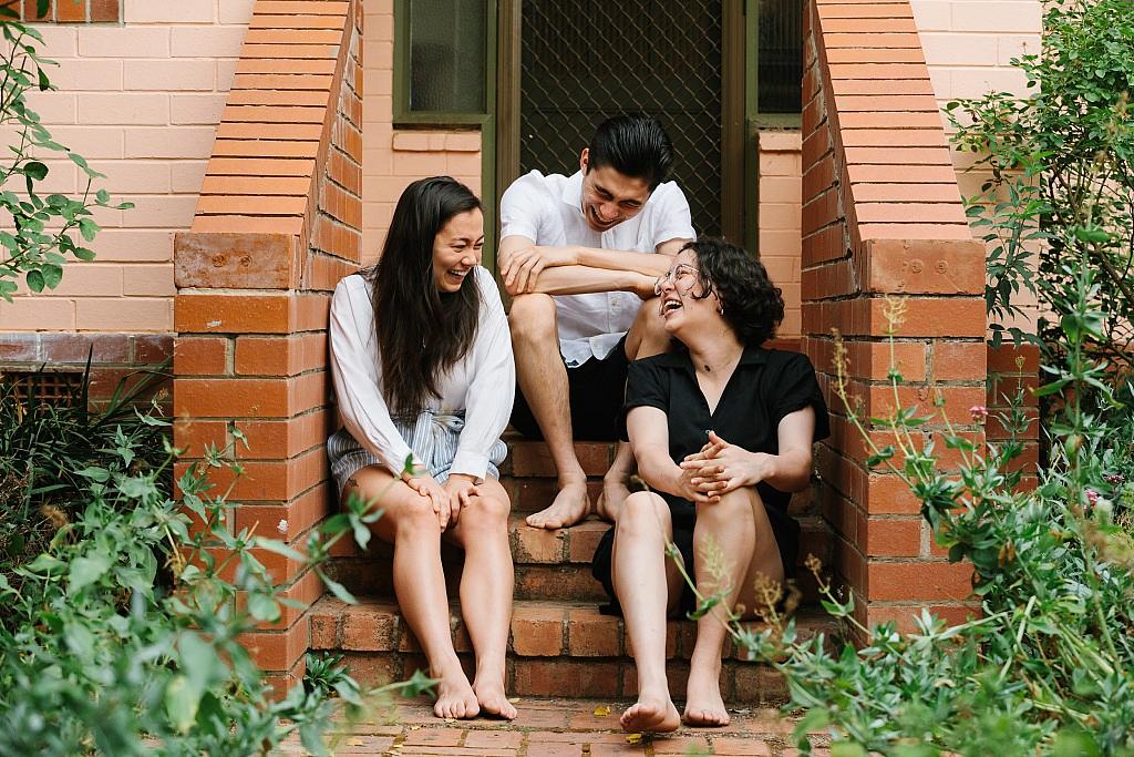 Three siblings laughing at each other