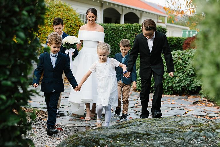 Bride walks with all her families children down the aisle