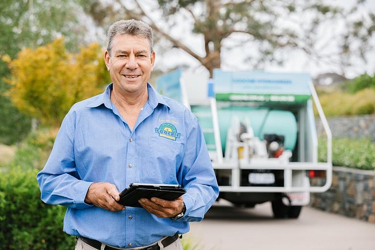 Man stands in front of coochie lawn truck