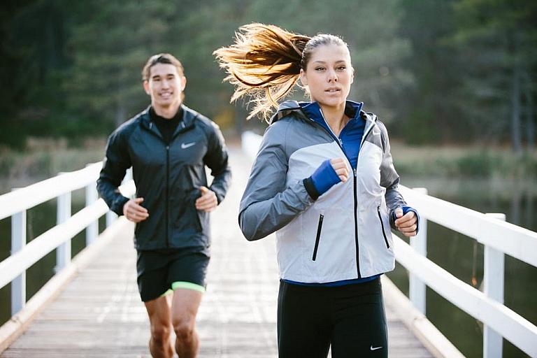 Woman runs ahead of man