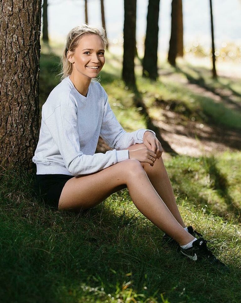 Woman sits under tree