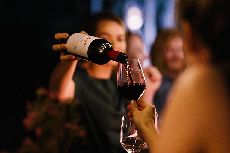 Woman pours glass of wine