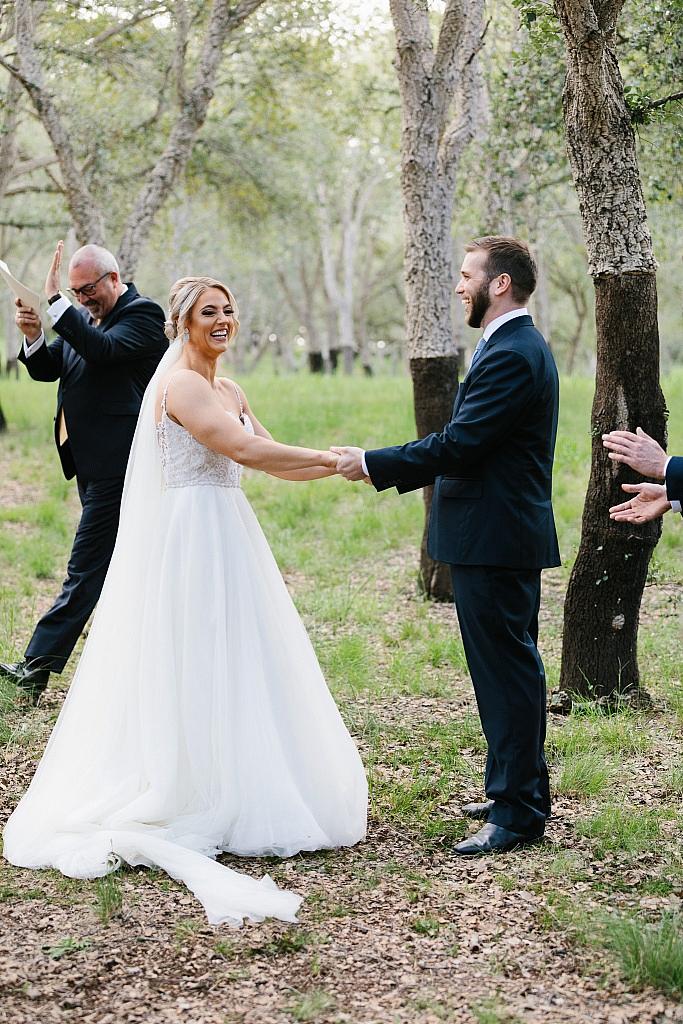 Celebrant claps as bride and groom are freshly married