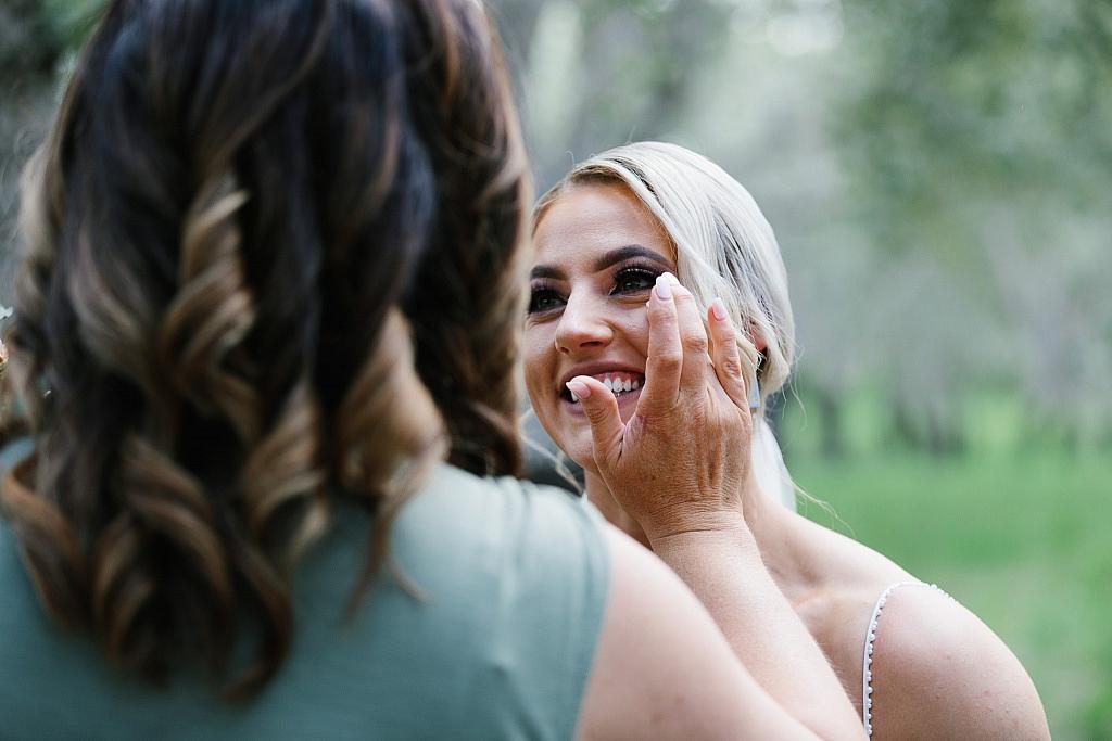 Bridesmaid fixes brides makeup