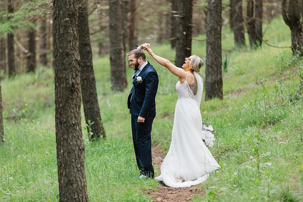 Bride twirls groom laughing