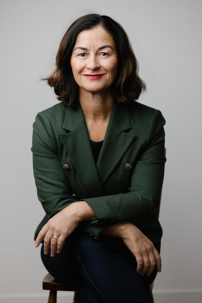 Fiona sits on chair in studio in Canberra